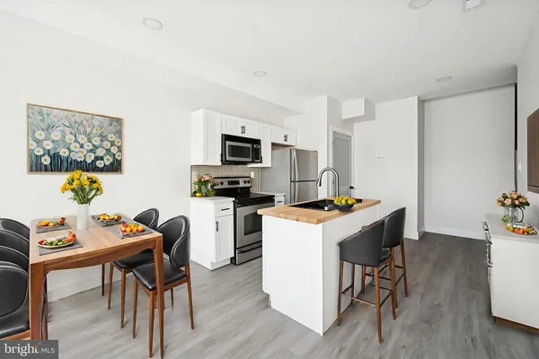 a kitchen that has a table and chairs in it
