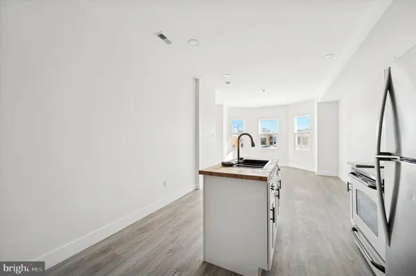 a view of a kitchen with sink and wooden floor