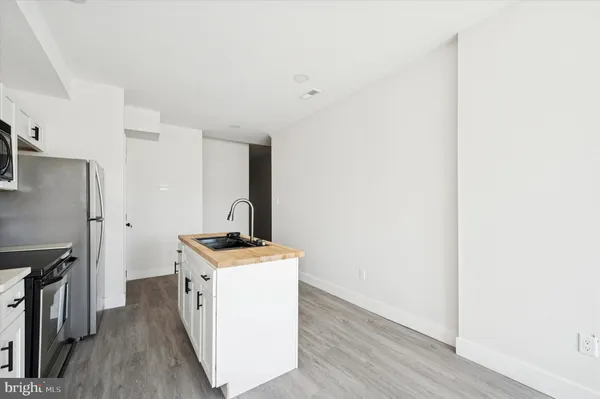 a kitchen with a stove and a refrigerator