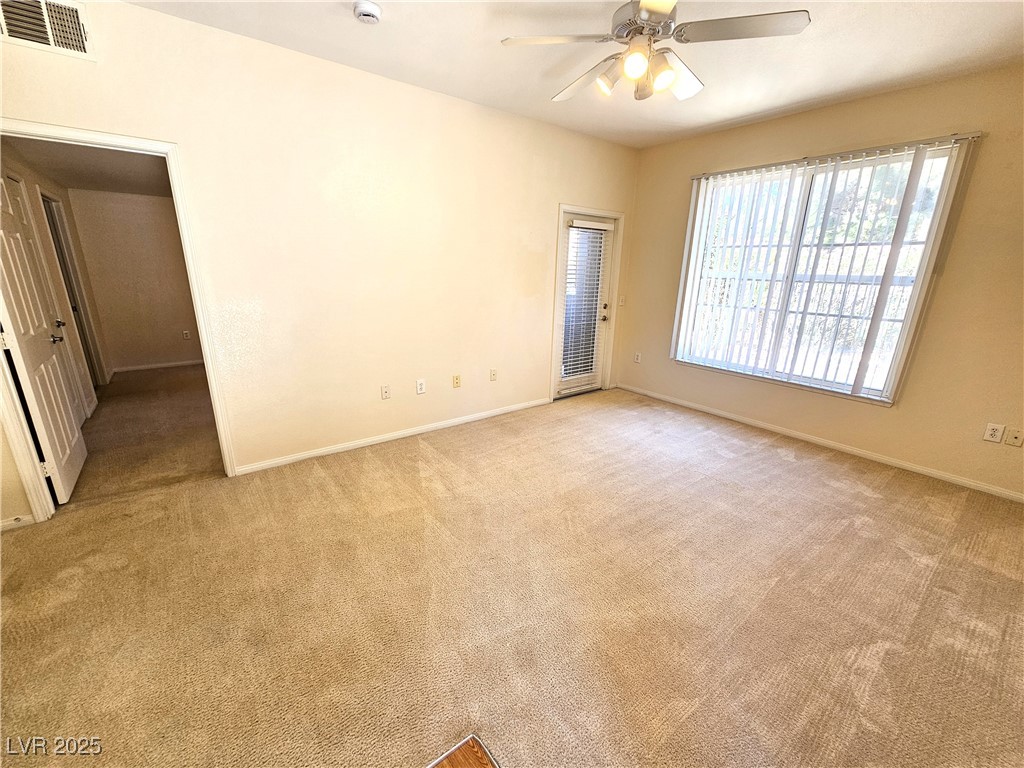 9000 South Las Vegas Boulevard, Unit 1176 Las Vegas, NV 89123 - Photo 14 of 26 Empty room with light carpet and a ceiling fan