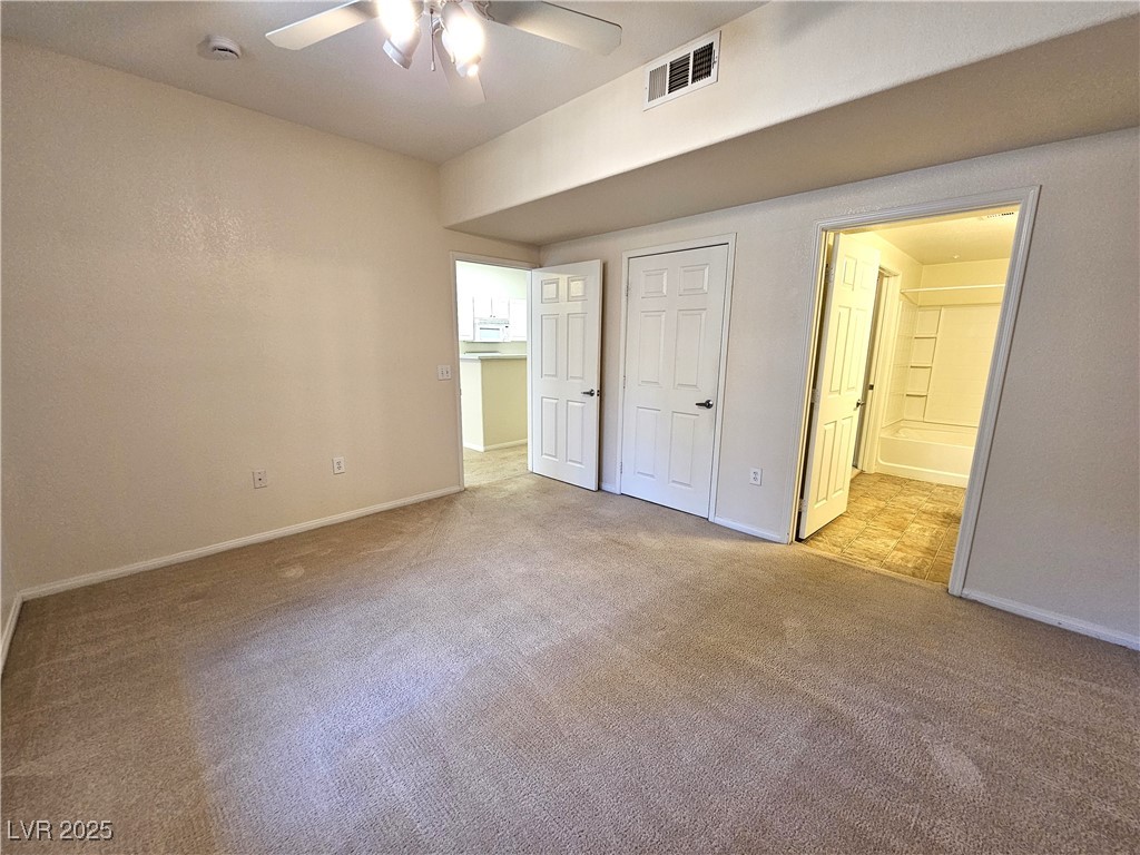 9000 South Las Vegas Boulevard, Unit 1176 Las Vegas, NV 89123 - Photo 17 of 26 Unfurnished bedroom featuring carpet floors, connected bathroom, and ceiling fan