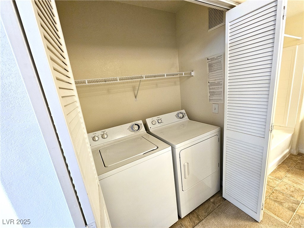 9000 South Las Vegas Boulevard, Unit 1176 Las Vegas, NV 89123 - Photo 22 of 26 Laundry area with washing machine and clothes dryer and light tile patterned floors