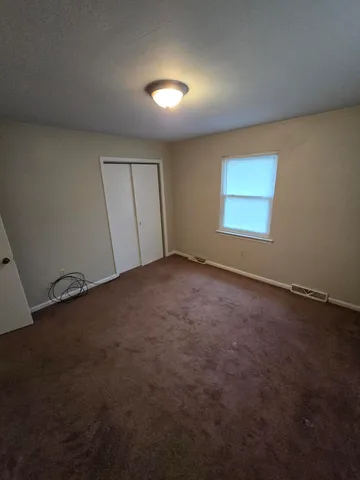 an empty room with a empty space and windows