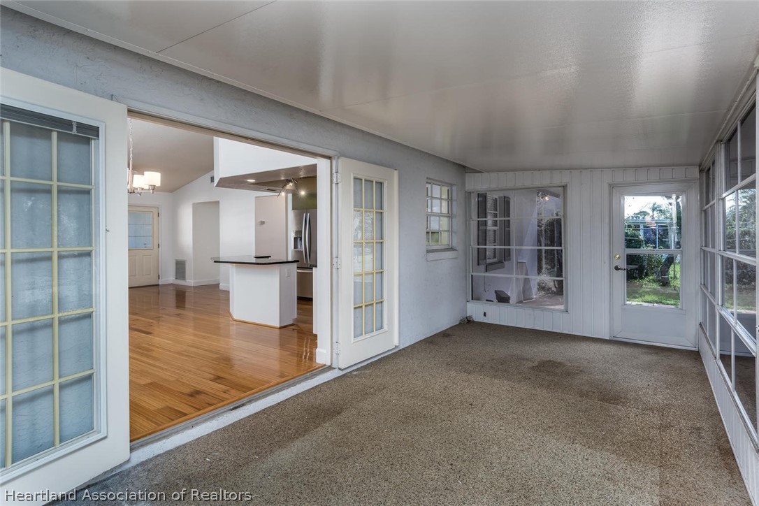 4115 Loquat Road Sebring, FL 33875 - Photo 13 of 28 en empty room with large glass door and furniture