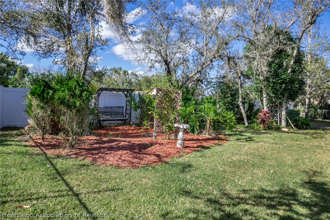 4115 Loquat Road Sebring, FL 33875 - Photo 16 of 28 a view of a house with backyard and sitting area