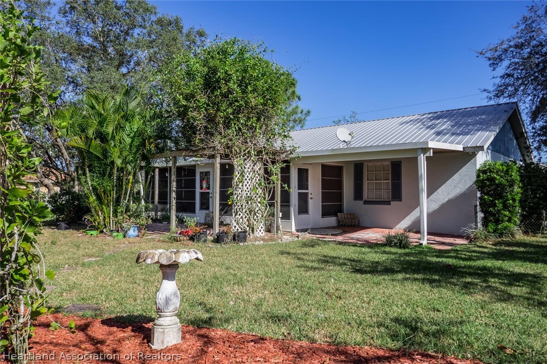 4115 Loquat Road Sebring, FL 33875 - Photo 17 of 28 a front view of a house with a yard and porch
