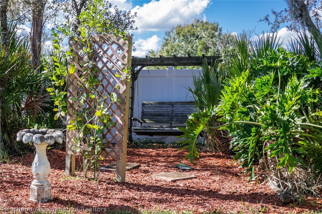4115 Loquat Road Sebring, FL 33875 - Photo 18 of 28 a backyard of a house with lots of green space