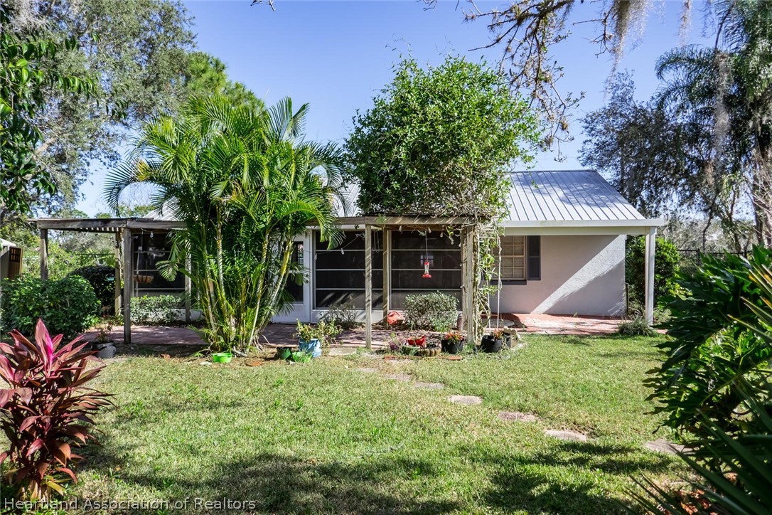 4115 Loquat Road Sebring, FL 33875 - Photo 19 of 28 a front view of house with yard and outdoor seating