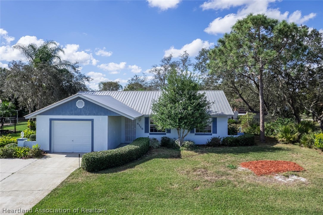 4115 Loquat Road Sebring, FL 33875 - Photo 28 of 28 a front view of a house with garden