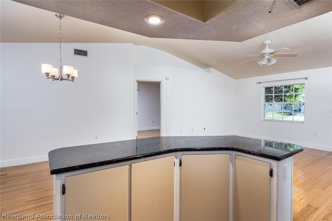 4115 Loquat Road Sebring, FL 33875 - Photo 4 of 28 a kitchen with a refrigerator and a sink