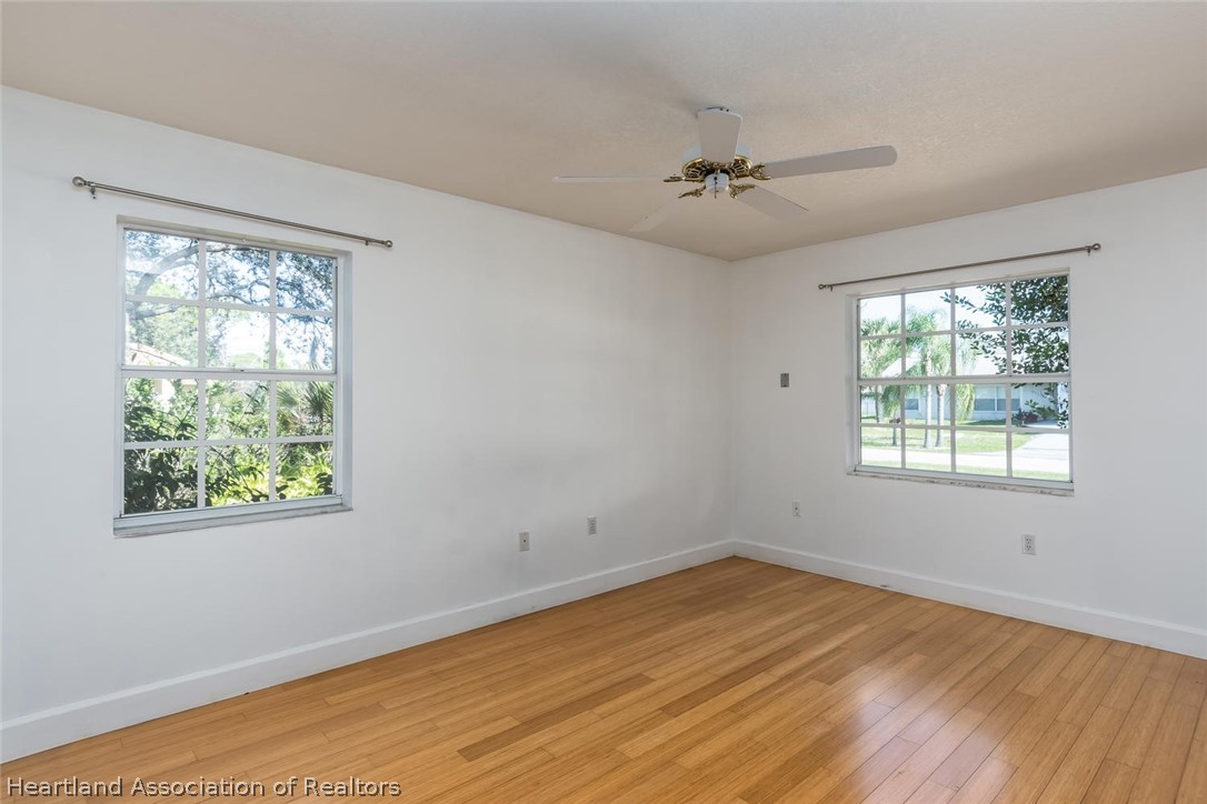 4115 Loquat Road Sebring, FL 33875 - Photo 7 of 28 a view of an empty room with wooden floor and a window