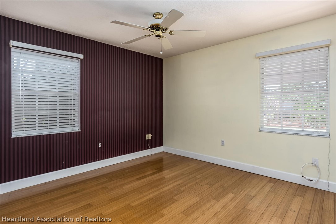 4115 Loquat Road Sebring, FL 33875 - Photo 10 of 28 a view of an empty room with a window and wooden floor