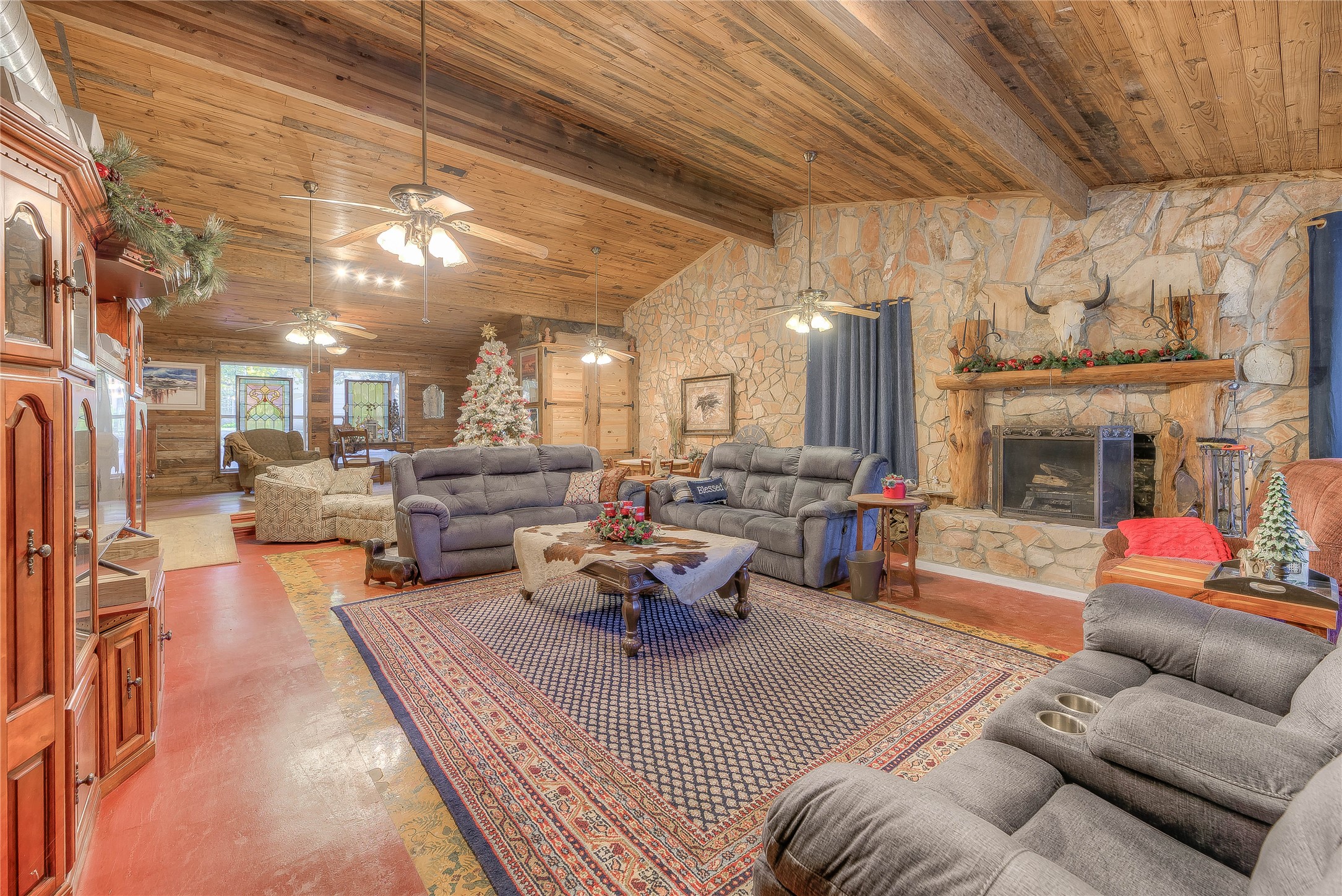 a living room with furniture kitchen view and a fireplace
