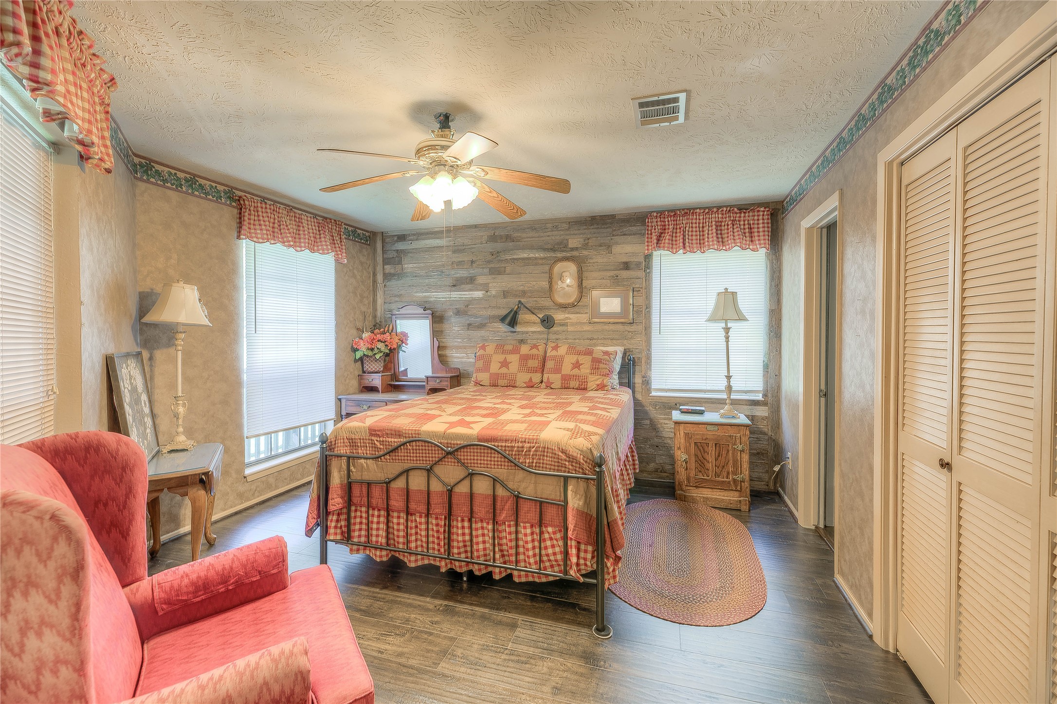 300 L Green Road Cleveland, TX 77328 - Photo 19 of 44 a bedroom with a bed and wooden floor