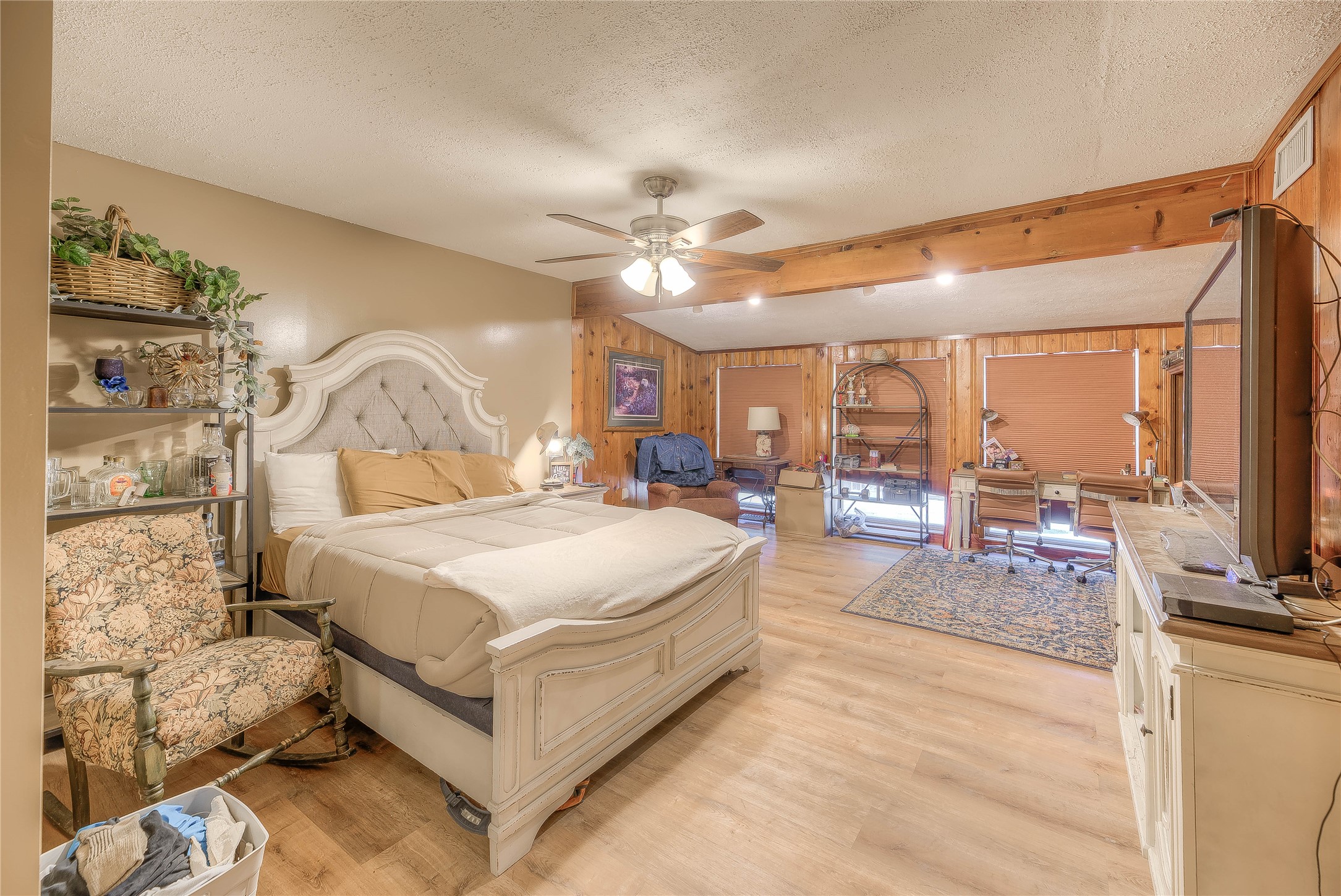 300 L Green Road Cleveland, TX 77328 - Photo 8 of 44 a spacious bedroom with a large bed and a chandelier