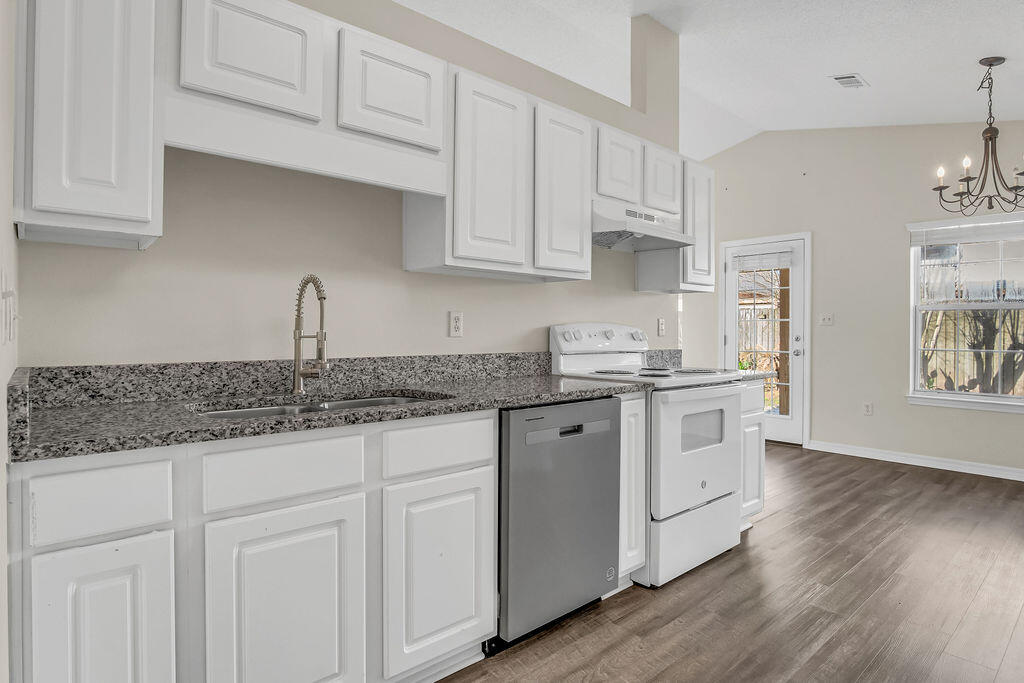 4641 Sunsail Circle Destin, FL 32541 - Photo 12 of 28 a kitchen with granite countertop white cabinets and a sink