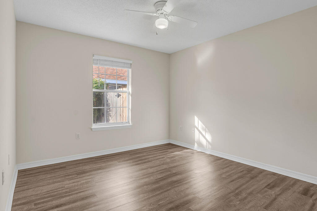 4641 Sunsail Circle Destin, FL 32541 - Photo 21 of 28 wooden floor in an empty room with a window