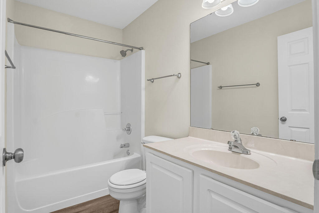 4641 Sunsail Circle Destin, FL 32541 - Photo 23 of 28 a bathroom with a sink a toilet and a mirror