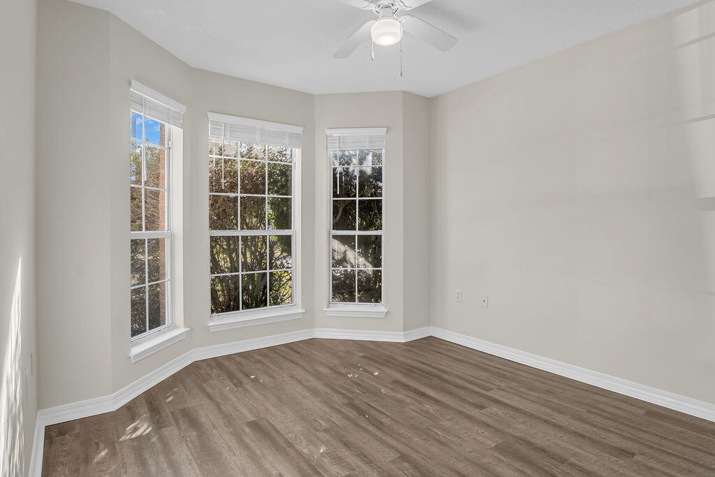 4641 Sunsail Circle Destin, FL 32541 - Photo 24 of 28 a view of an empty room with wooden floor and a window