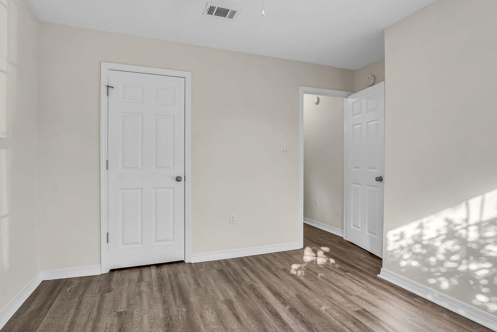 4641 Sunsail Circle Destin, FL 32541 - Photo 25 of 28 a view of an empty room and wooden floor