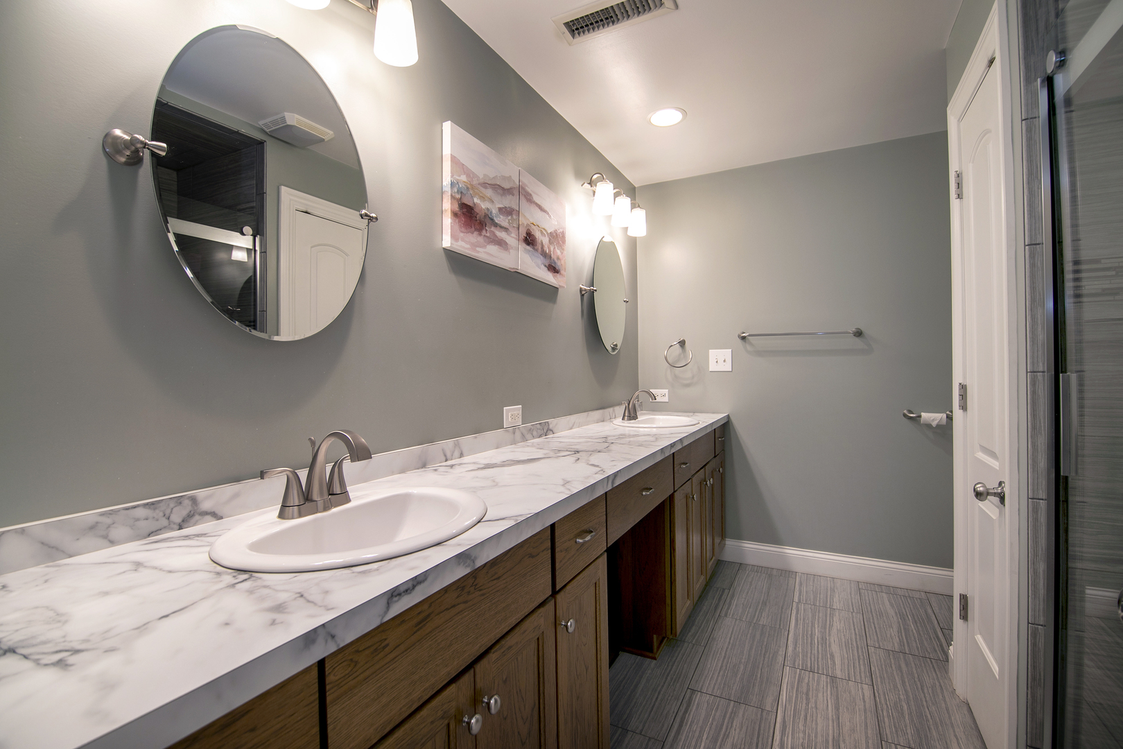 1305 Oaktree Lane Kankakee, IL 60901 - Photo 24 of 47 a bathroom with a granite countertop sink a large mirror and vanity