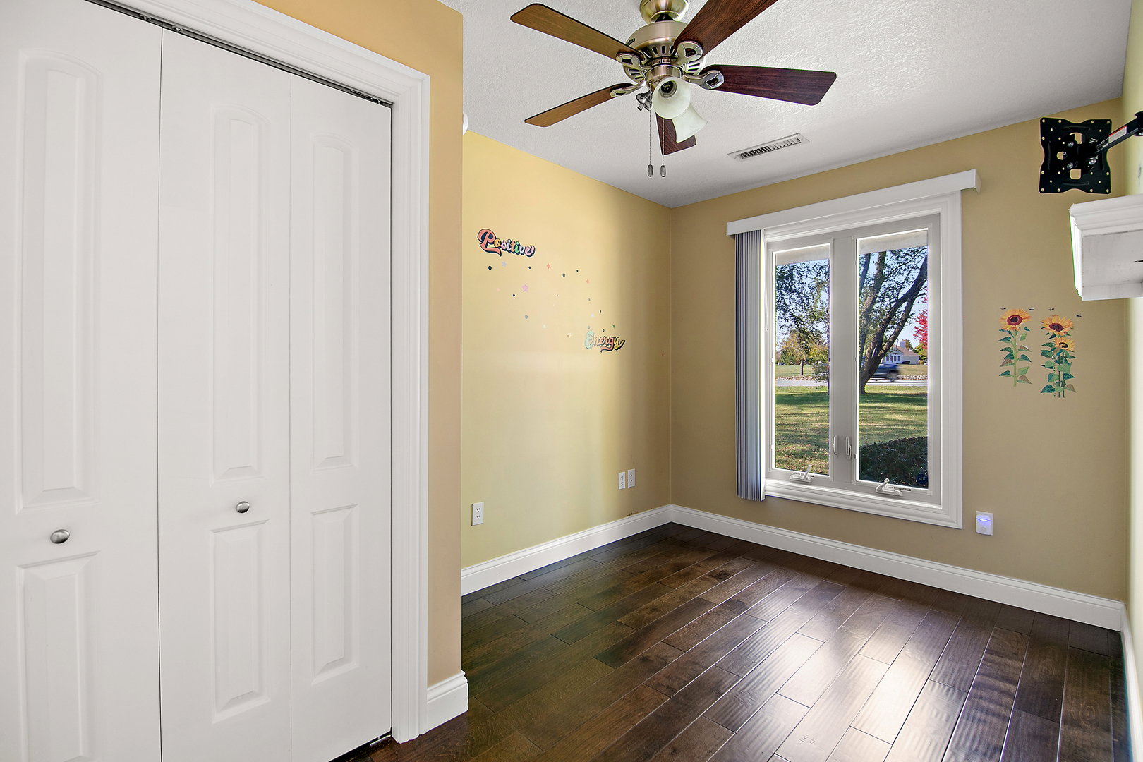 1305 Oaktree Lane Kankakee, IL 60901 - Photo 31 of 47 an empty room with wooden floor fan and windows