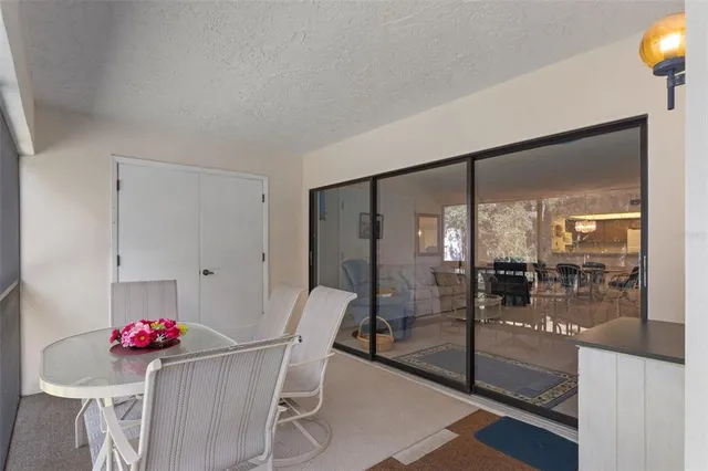a view of a dining room with furniture a chandelier and wooden floor