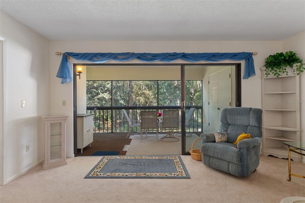 1 Cypress Run, Unit 14B Homosassa, FL 34446 - Photo 13 of 73 a living room with furniture and a floor to ceiling window