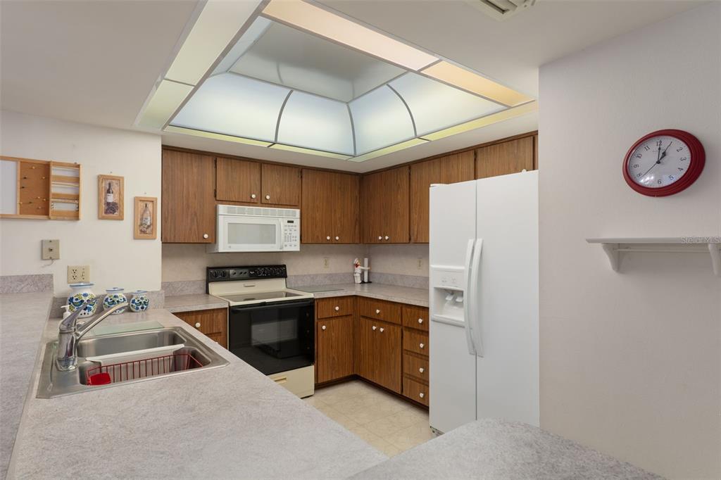 1 Cypress Run, Unit 14B Homosassa, FL 34446 - Photo 19 of 73 a kitchen with stainless steel appliances granite countertop a sink a stove and refrigerator