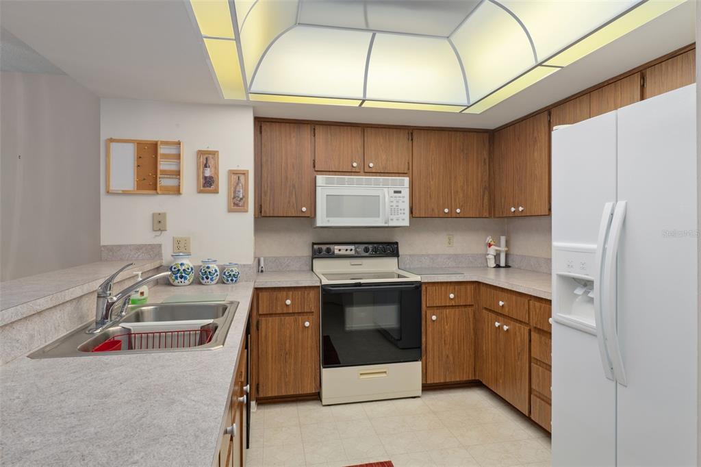 1 Cypress Run, Unit 14B Homosassa, FL 34446 - Photo 20 of 73 a kitchen with stainless steel appliances a stove a sink and a refrigerator