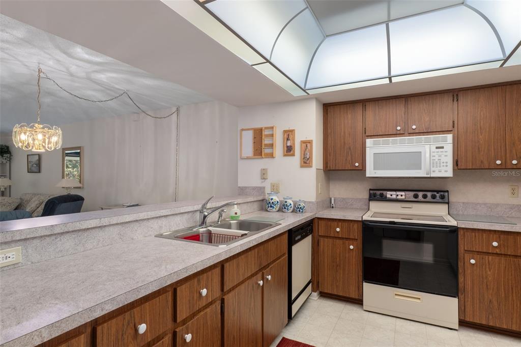 1 Cypress Run, Unit 14B Homosassa, FL 34446 - Photo 21 of 73 a kitchen with stainless steel appliances granite countertop a sink stove and cabinets