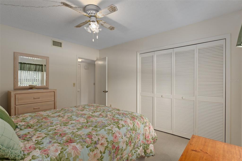 1 Cypress Run, Unit 14B Homosassa, FL 34446 - Photo 36 of 73 a bedroom with a bed and a chandelier fan