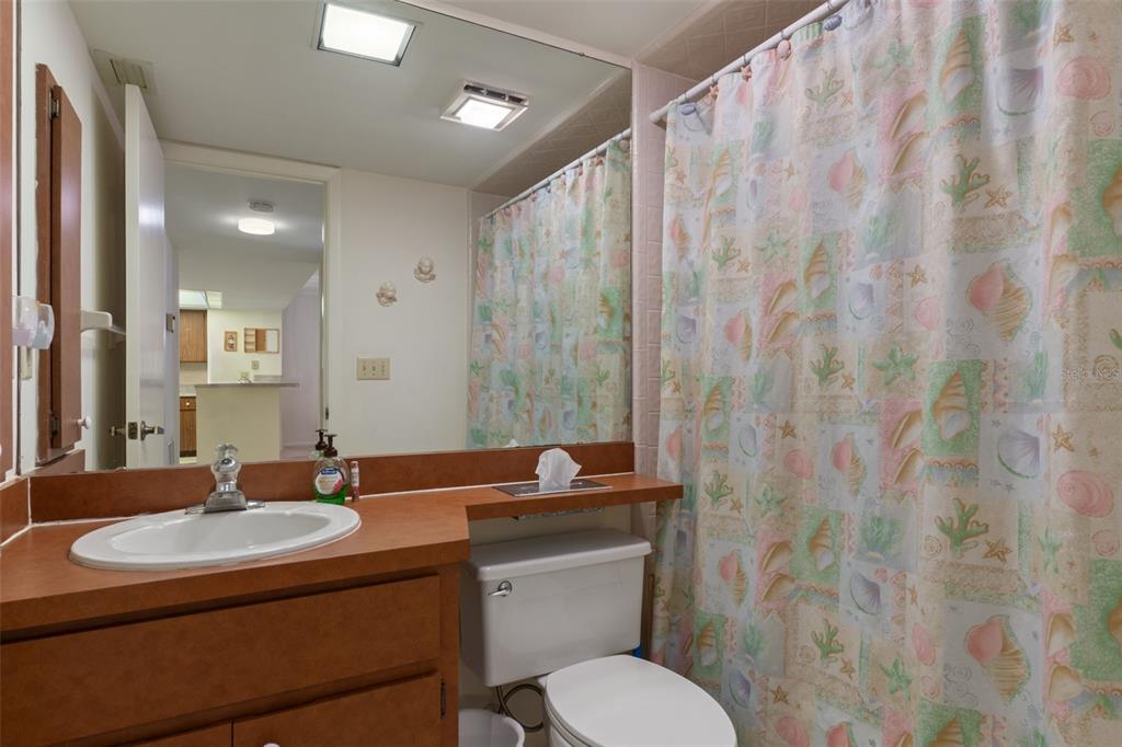 1 Cypress Run, Unit 14B Homosassa, FL 34446 - Photo 37 of 73 a bathroom with a granite countertop sink a toilet and shower curtain