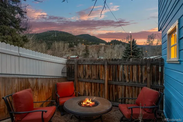 a view of a house with a yard and sitting area