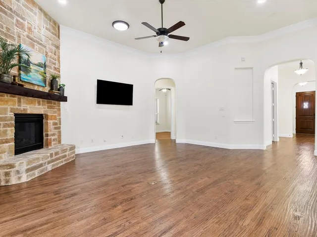 a view of an empty room with a fireplace and a window