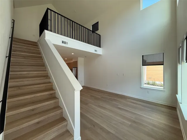 a view of entryway and hall with wooden floor