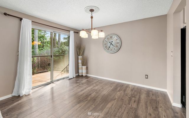 a view of a room with wooden floor and a window