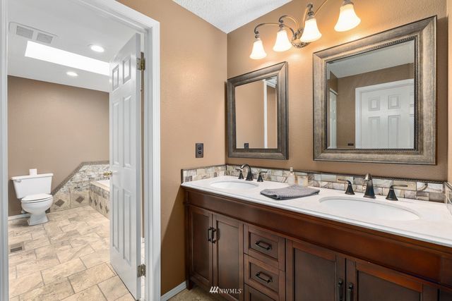 a bathroom with a double vanity sink and a mirror