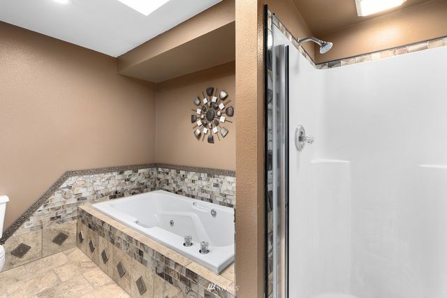 a bathroom with a tub and shower