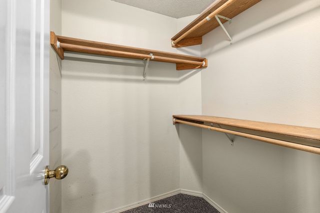 a view of closet with wooden floor