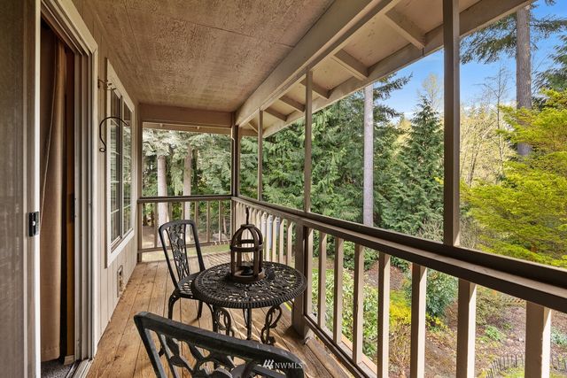 a view of a chairs and table in the balcony