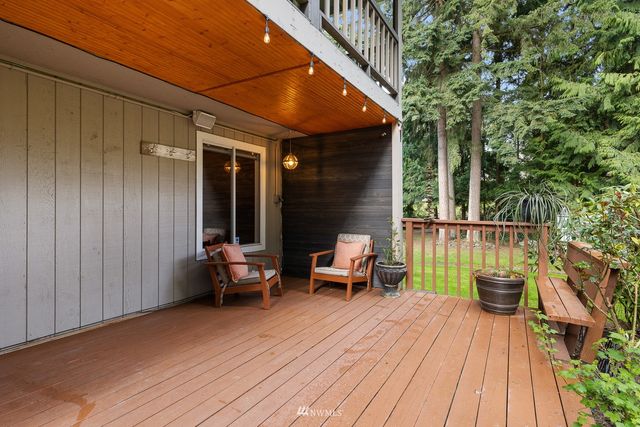 a balcony with furniture and wooden floor