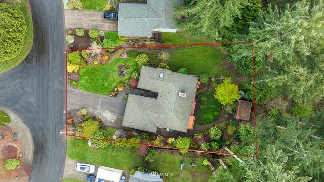 an aerial view of a house with a yard basket ball court and outdoor seating