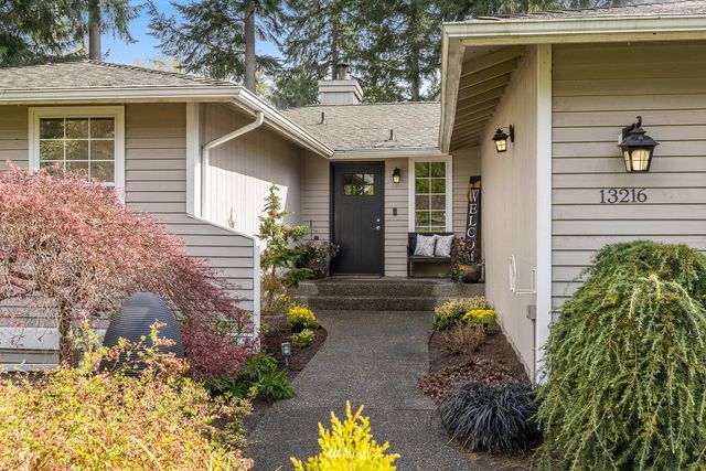 a front view of a house with yard and outdoor seating