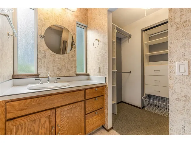 a bathroom with a sink a mirror and a shower