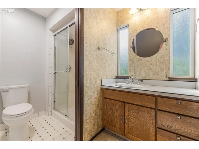 a bathroom with a sink a toilet and a mirror