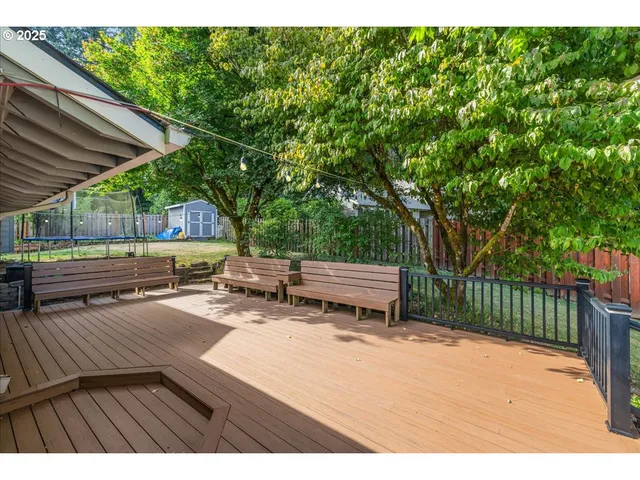 a backyard of a house with barbeque oven and outdoor seating
