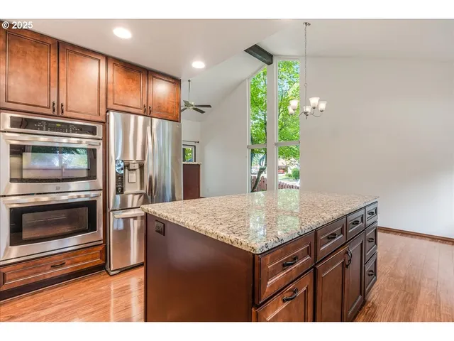 a kitchen with a sink cabinets and stainless steel appliances