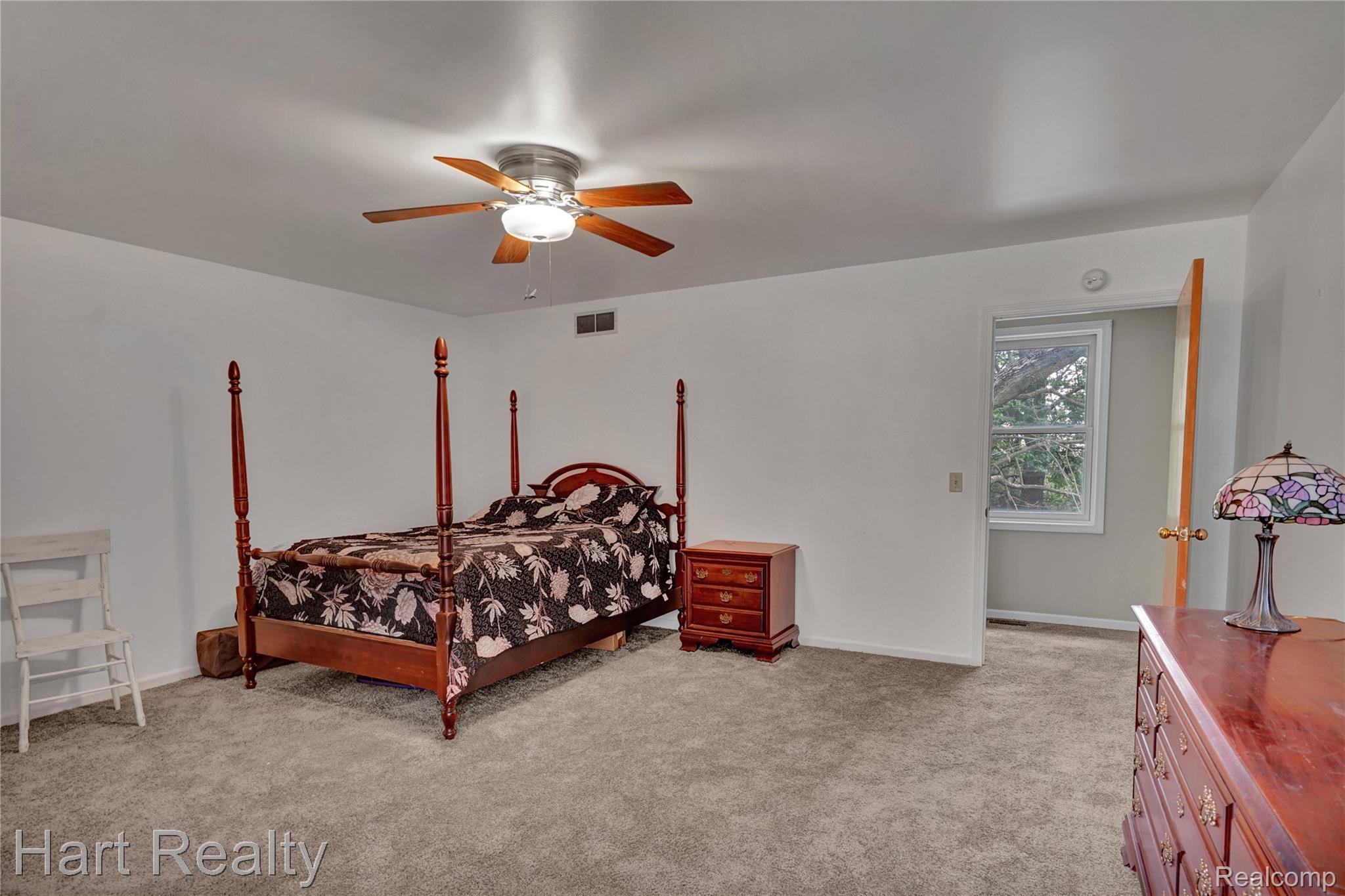 7167 Brown School Road North Branch, MI 48461 - Photo 32 of 51 Spacious room featuring neutral carpeting, white walls, a ceiling fan with integrated lighting, and a recessed window providing natural light