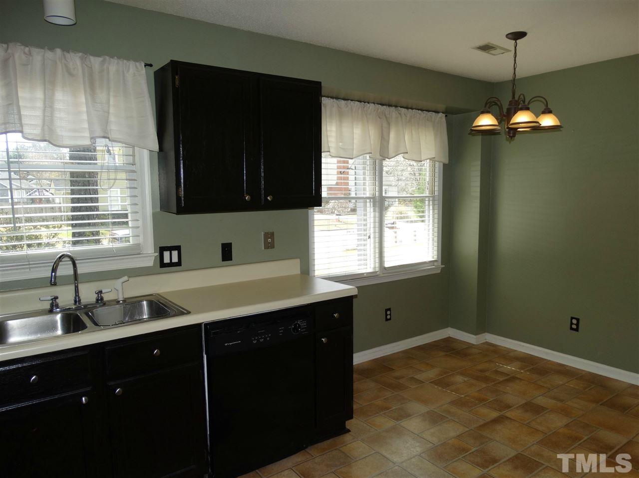 109 Longneedle Court Raleigh, NC 27603 - Photo 12 of 23 a kitchen with a sink stove and microwave